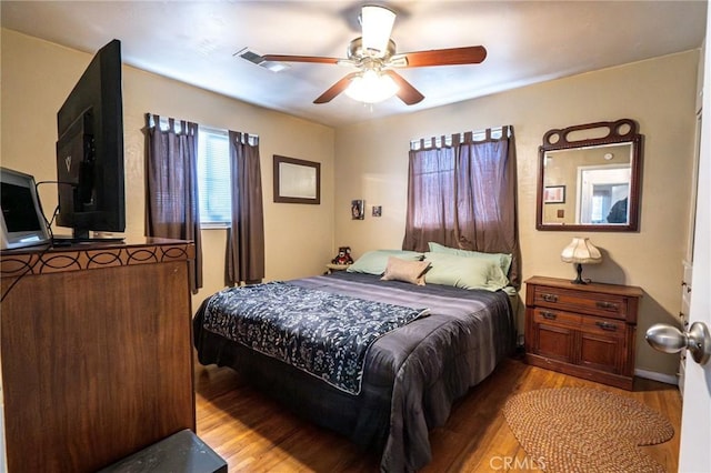 bedroom with ceiling fan and wood-type flooring