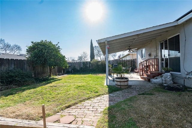 view of yard featuring a patio and ceiling fan