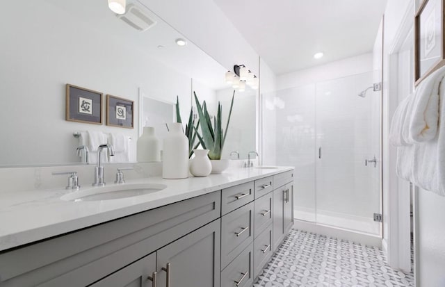 bathroom featuring vanity and a shower with door