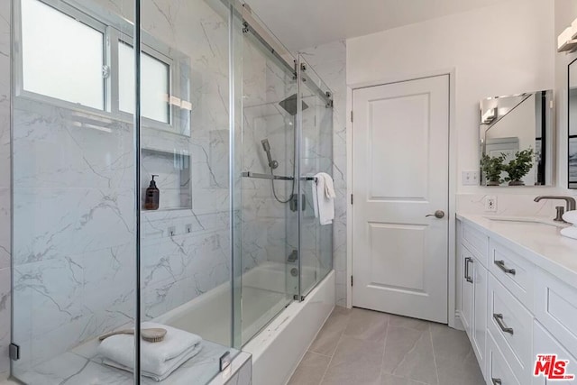 bathroom featuring enclosed tub / shower combo and vanity