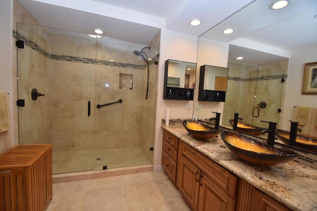 bathroom with vanity and a shower with shower door