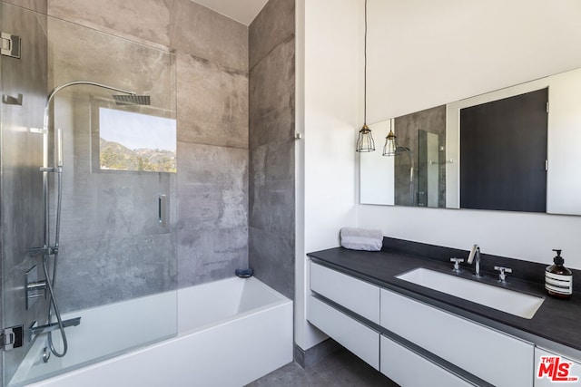 bathroom with tiled shower / bath combo and vanity