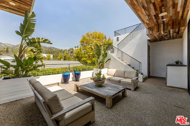 view of patio / terrace with a mountain view, outdoor lounge area, and a balcony