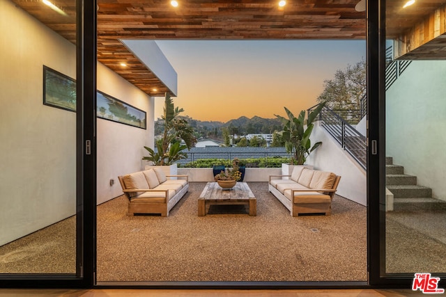 patio terrace at dusk featuring outdoor lounge area