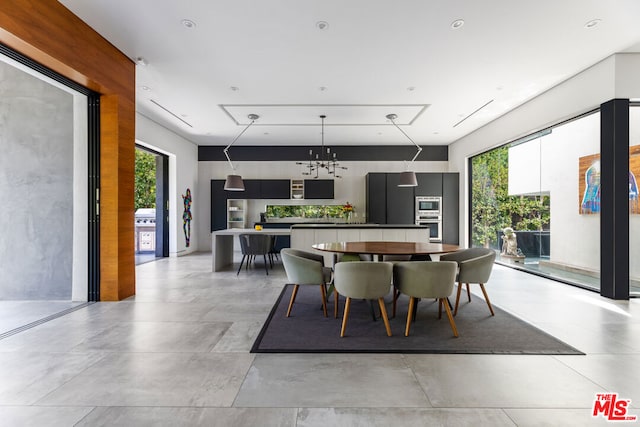 dining space with a healthy amount of sunlight and a notable chandelier