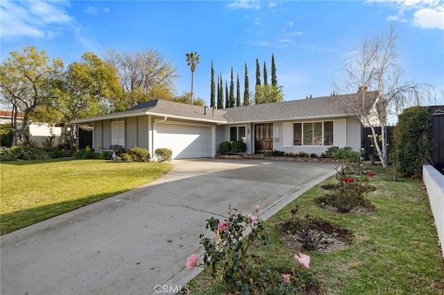 ranch-style house with a garage and a front lawn