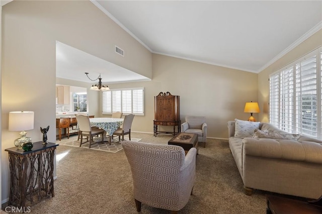 carpeted living room featuring crown molding, vaulted ceiling, and an inviting chandelier