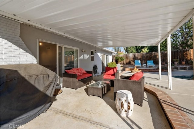 view of patio featuring area for grilling and an outdoor living space with a fire pit