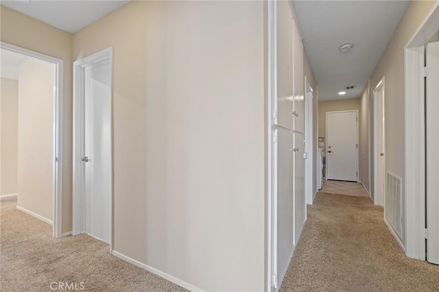 hallway with light colored carpet