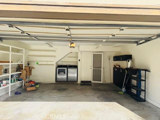 garage with a garage door opener and washer and dryer