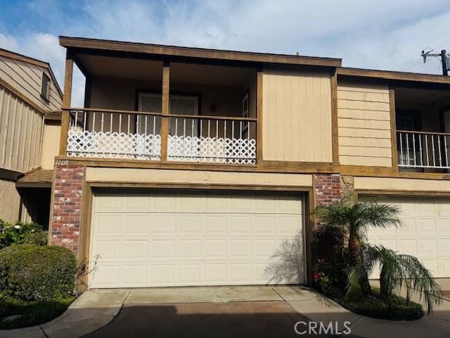 townhome / multi-family property featuring a garage and a balcony