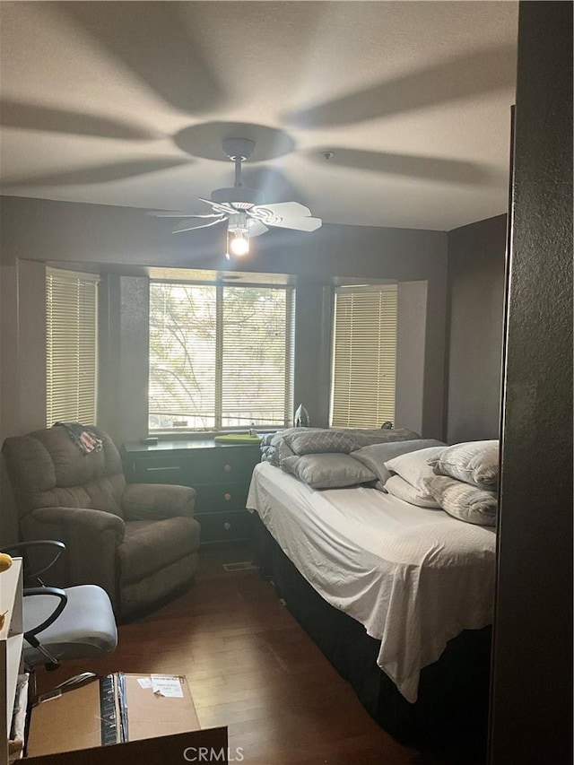 bedroom with hardwood / wood-style floors and ceiling fan