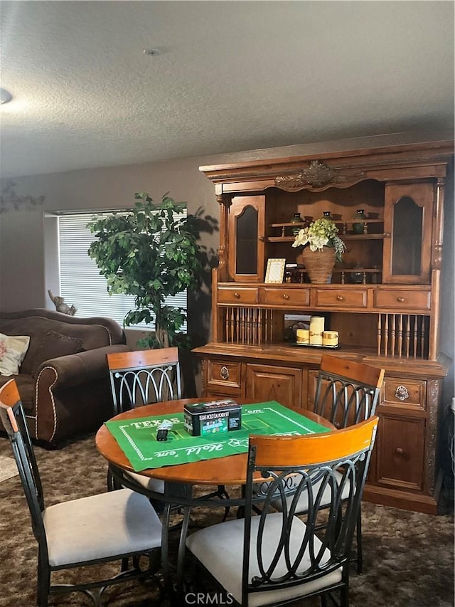 dining space with a textured ceiling