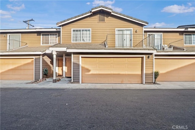 view of front of house featuring a garage and a balcony