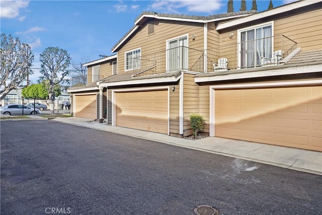 view of front of house with a garage and a balcony