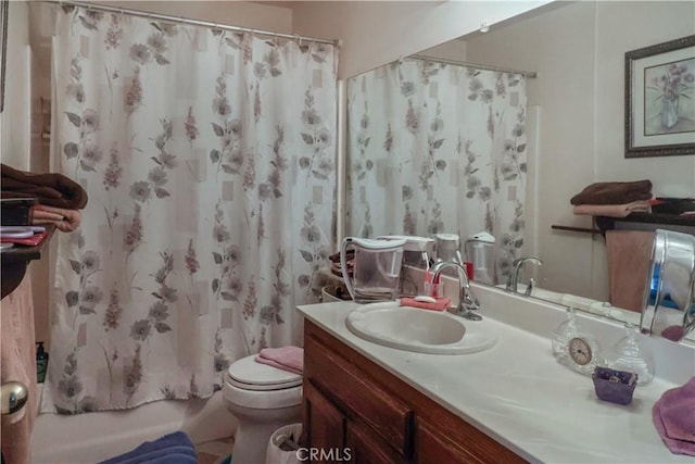 full bathroom with shower / bath combo, vanity, and toilet