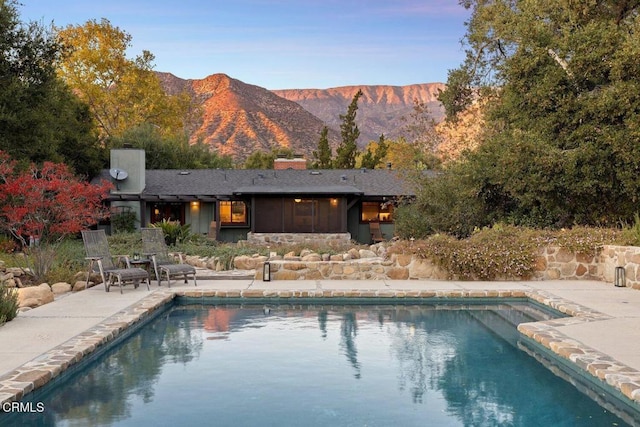 view of swimming pool featuring a mountain view and a patio