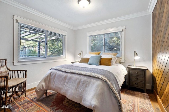 bedroom with wood-type flooring and crown molding