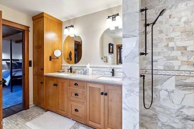 bathroom featuring a tile shower, vanity, and tasteful backsplash