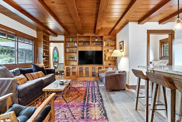 living room with beamed ceiling, wooden ceiling, and light hardwood / wood-style flooring