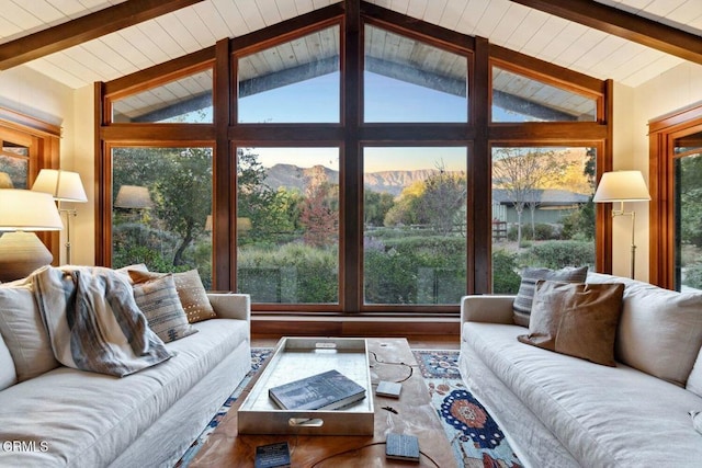 living room with a mountain view and lofted ceiling with beams