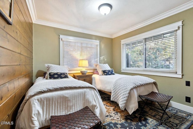 bedroom featuring crown molding and wooden walls