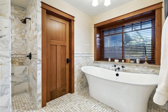 bathroom featuring tile walls and independent shower and bath