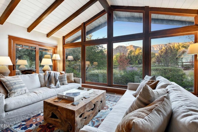 living room with a mountain view and vaulted ceiling with beams