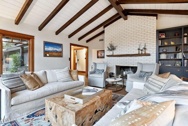 living room with hardwood / wood-style floors, a fireplace, and lofted ceiling with beams