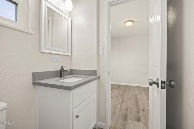 bathroom featuring vanity, toilet, and hardwood / wood-style floors