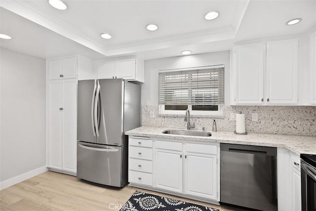 kitchen with stainless steel refrigerator, dishwashing machine, sink, and white cabinets