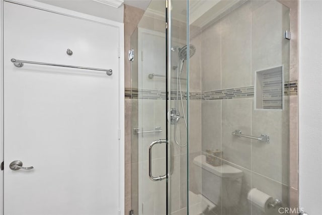 bathroom featuring a shower with shower door