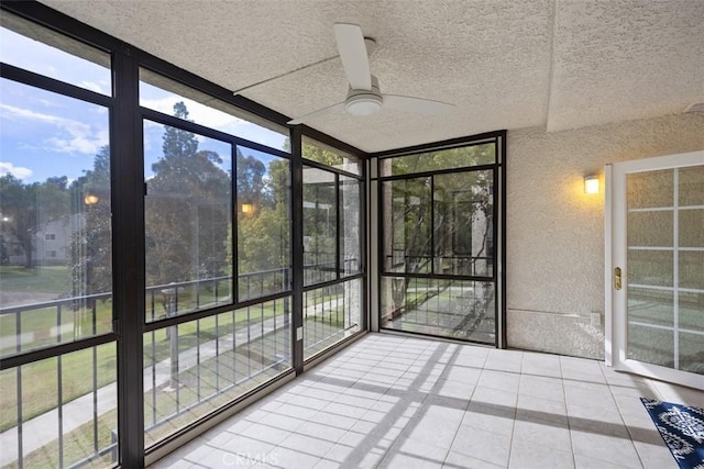 unfurnished sunroom with plenty of natural light and ceiling fan