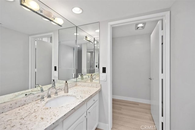 bathroom featuring wood-type flooring and vanity