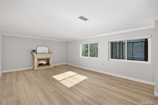 unfurnished living room featuring crown molding and light wood-type flooring