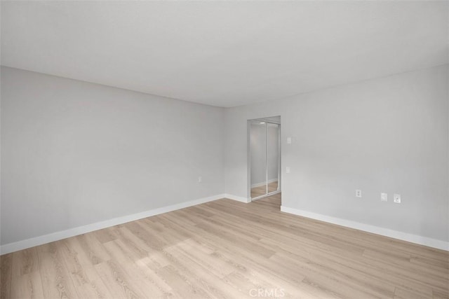 spare room with light hardwood / wood-style flooring