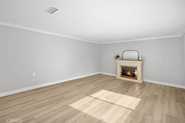 unfurnished living room featuring crown molding and light hardwood / wood-style flooring