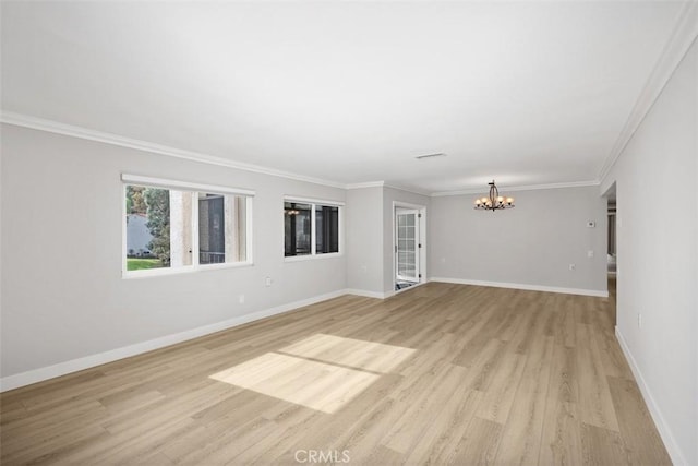 unfurnished living room with ornamental molding, a chandelier, and light wood-type flooring