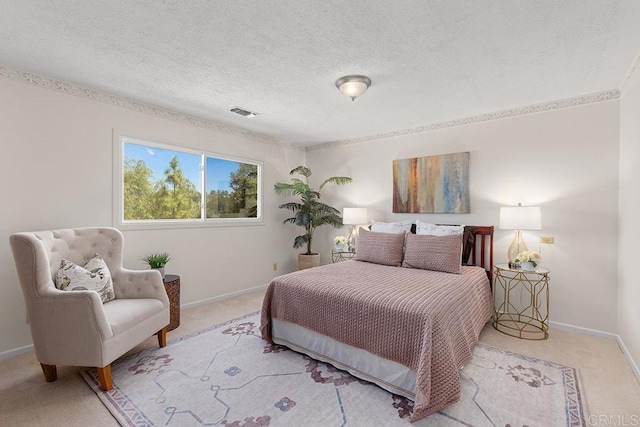 bedroom with light carpet and a textured ceiling