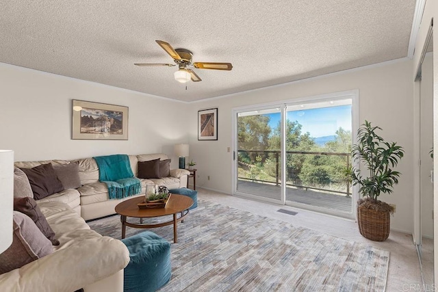 carpeted living room with crown molding, a textured ceiling, and ceiling fan