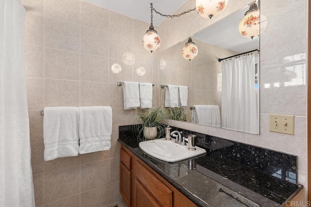 bathroom with vanity and tile walls