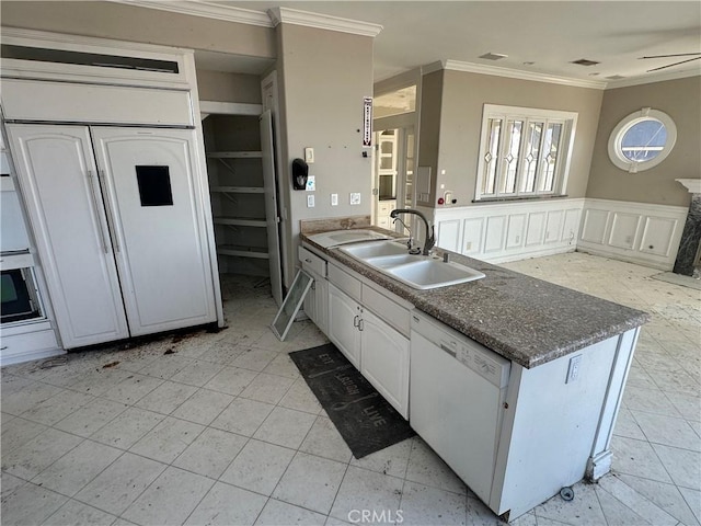 kitchen featuring sink, white cabinetry, crown molding, dishwasher, and a high end fireplace