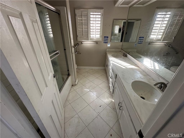 bathroom with tile patterned flooring, vanity, plenty of natural light, and a shower with shower door