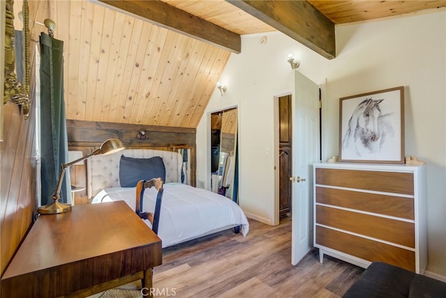 bedroom featuring lofted ceiling with beams, wood-type flooring, and wooden ceiling