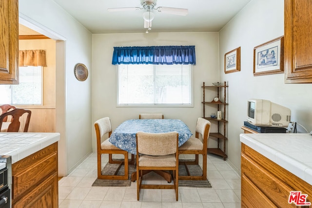 dining room with light tile patterned flooring and ceiling fan