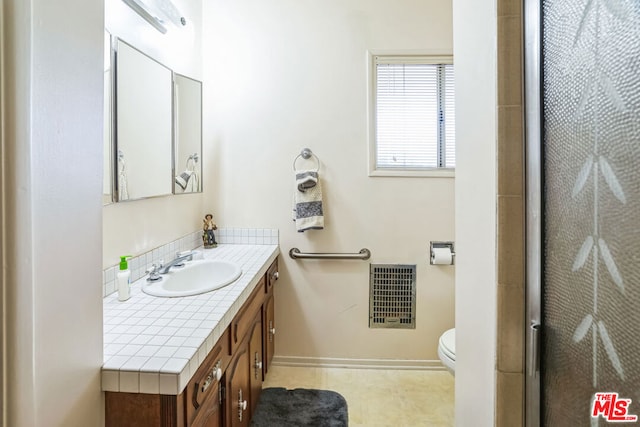 bathroom featuring vanity and toilet