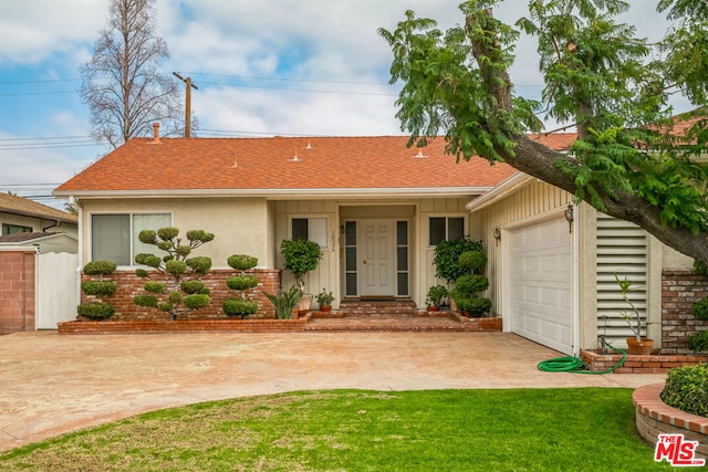 single story home with a garage and a front yard