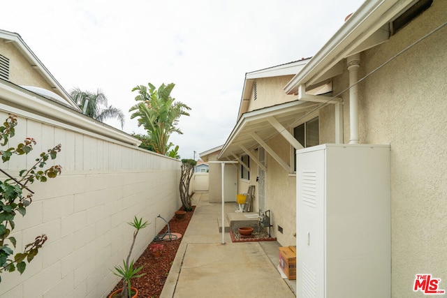 view of side of home with a patio area