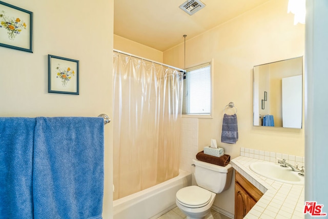 full bathroom featuring toilet, vanity, and shower / bath combo with shower curtain