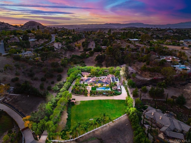 aerial view at dusk featuring a mountain view